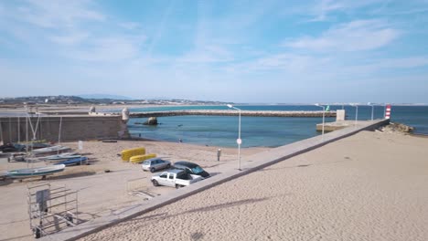 A-sunny-day-at-Praia-da-Batata-in-Lagos,-Portugal-with-boats-and-clear-blue-skies