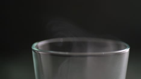 Macro-of-a-lot-of-flowing-smoke-over-the-glass