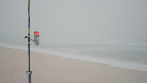 Fishing-rod-on-a-foggy-beach-day-at-Costa-Nova,-Aveiro,-Portugal