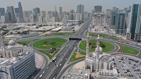 Bird's-eye-view-of-Sharjah's-Al-Khan-Bridge,-highlighting-the-four-new-identical-mosques-at-each-corner-in-the-united-arab-emirates