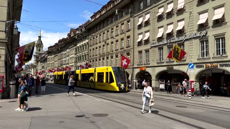 Pov-walk-in-center-of-Bern-City-with-tram-on-main-street-of-Capital