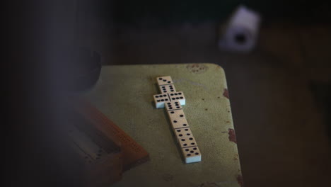 Dominoes-on-Table-in-Alcatraz-Prison-Cell,-View-Behind-Metal-Bars