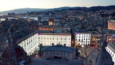 Twilight-aerial-over-illuminated-Piazza-de-Ferrari-swarming-with-people-in-Genoa