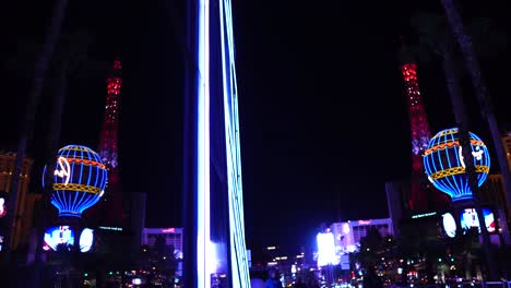 Las-Vegas-USA,-Paris-Hotel-Casino-Eiffel-Tower-and-Balloon-at-NIght,-Mirror-Reflection-on-Cosmopolitan-Building