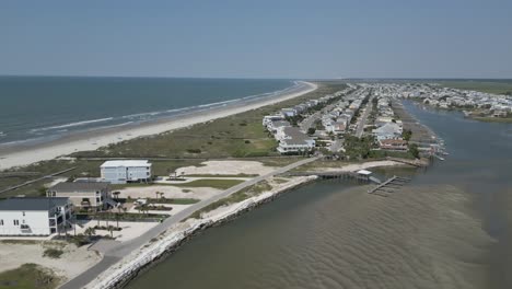 4k-rotating-drone-clip-of-the-north-end-of-Sunset-Beach,-NC-on-a-bright-sunny-day-with-blue-skies