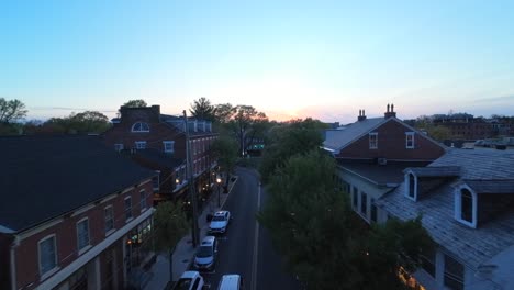 Drone-flight-over-main-street-of-small-american-town-at-dusk