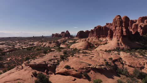 Serpentine-road-winding-through-the-middle-of-Arches-National-Park-on-a-beautiful-sunny-day