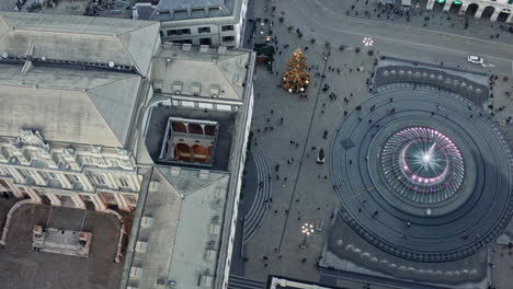 Twisting-top-drone-view-over-Piazza-De-Ferrari-with-pedestrians-around-fountain