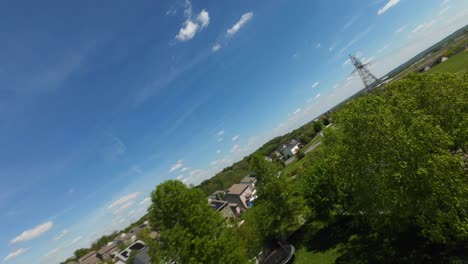 FPV-drone-shot-of-street-in-american-neighborhood-with-driving-cars