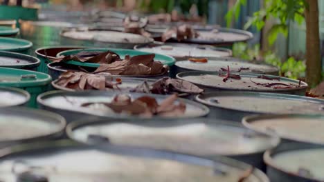 Row-of-barrels-containing-chemistry-waste-liquid-placed-in-outdoor