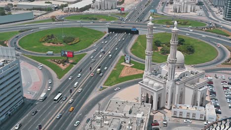 On-a-sunny-day,-traffic-flows-on-Sharjah's-Al-Wahda-Street,-known-as-Sharjah-Dubai-Road-in-the-UAE