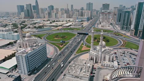 Bird's-eye-view-of-Sharjah's-Al-Khan-Bridge,-highlighting-the-four-new-identical-mosques-at-each-corner-in-the-united-arab-emirates