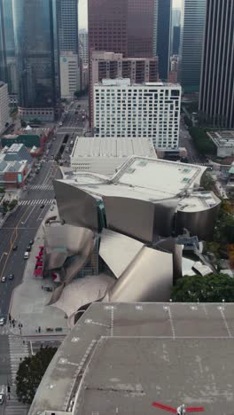 Los-Angeles-USA,-Vertical-Aerial-View-of-Walt-Disney-Concert-Hall,-Downtown-Buildings-and-Traffic,-Drone-Shot