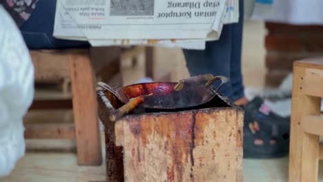 The-tool-for-making-"canting"-batik-cloth-is-in-a-pan-filled-with-hot-liquid-wax