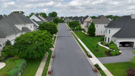 Aerial-approaching-Shot-of-american-neighborhood-with-walking-people-and-children-on-scooter