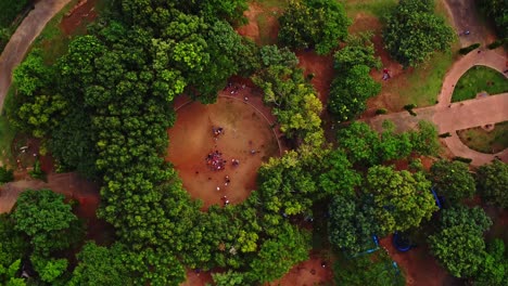 Top-down-aerial-view-of-a-large-crowd-in-a-beautiful-green-park-in-Abuja,-Nigeria