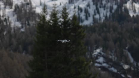 DJI-Mini-4K-drone-flies-away-outdoors-with-defocused-mountain-background