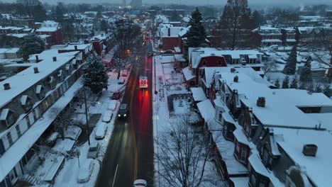 Ambulance-and-police-car-on-road-of-snowy-american-town