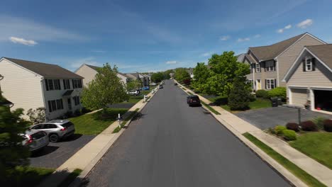 FPV-flight-in-peaceful-american-neighborhood-with-parked-cars-on-street