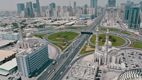 Bird's-eye-view-of-Sharjah's-Al-Khan-Bridge,-highlighting-the-four-new-identical-mosques-at-each-corner-in-the-united-arab-emirates