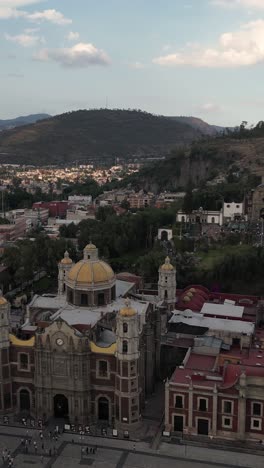 Drone-shot-tilted-to-the-left-over-the-Basilica-of-Guadalupe-in-CDMX,-vertical-mode