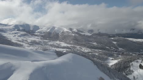 Eine-Atemberaubende-Aussicht-Auf-Einen-Schneebedeckten-Bergrücken-Mit-Scharfen-Gipfeln-Und-Tiefem-Schnee