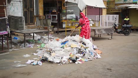 Street-sweeper-cleans-the-street-gathering-garbage-at-one-place-to-be-picked-up-later