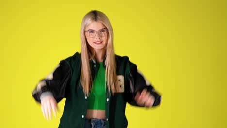 Joyful-Pretty-Blonde-Young-Girl-Waving-Hands,-Raising-Arms-And-Smiling,-Colorful-Studio-Shot