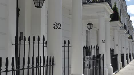 Exterior-of-numbered-white-stucco-mansion-houses-in-South-Kensington-London-United-Kingdom-June-2024