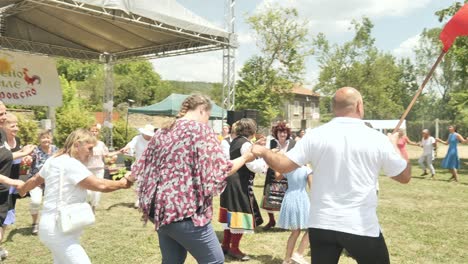 Bulgarian-mayor-waving-flag-leads-traditional-dance-Petrovden-summer-festival