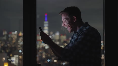 Man-lights-up-with-joy-and-excitement-as-he-receives-fantastic-news-on-smartphone