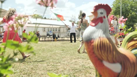 Man-holding-Bulgarian-flag-leads-traditional-dancing-at-chicken-festival