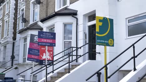 Exterior-of-house-in-Ealing-with-many-different-estate-agents-signs-London-United-Kingdom-June-2024