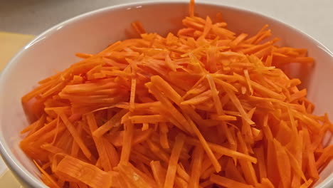 Grated-carrot,-bright-orange-vegetable-used-for-cooking,-healthy-herbaceous