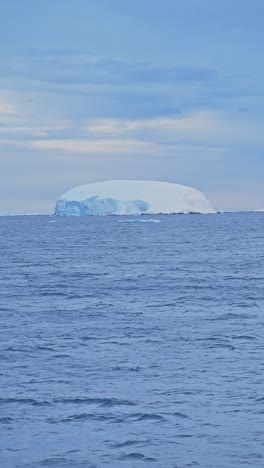 Eisberg-Bei-Sonnenuntergang-Im-Meerwasser-Der-Antarktis,-Vertikales-Video-Für-Soziale-Medien,-Instagram-Reels-Und-Tiktok-Der-Winterseelandschaft-Und-Der-Eisigen-Landschaft-Der-Antarktis