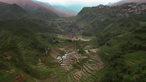 Aerial-view-of-Sa-Pa-nestled-in-Vietnam's-Hoàng-Liên-Son-Mountains,-featuring-the-terraced-rice-fields-of-Muong-Hoa-Valley