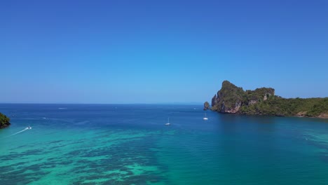 Catamaran-is-sailing-on-turquoise-water-near-a-tropical-Thai-island-on-a-sunny-day