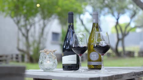 Slow-establishing-shot-of-a-glass-of-red-and-white-wine-sitting-on-a-table