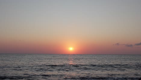 Bali's-stunning-sunset-over-the-calm-ocean-horizon-captured-in-Indonesia