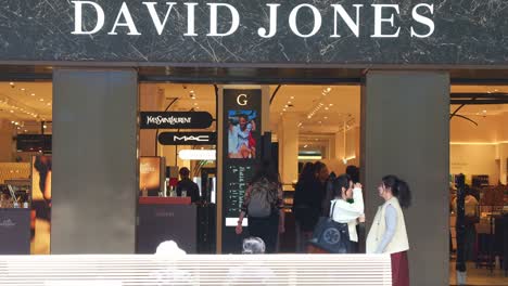 The-foot-traffic-of-the-storefront-of-David-Jones-flagship-store-in-bustling-downtown-Melbourne-city,-with-pedestrians-strolling-on-Bourke-Street-Mall-and-shoppers-shopping-in-the-store