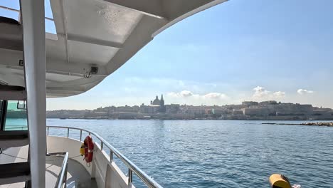 View-from-a-boat-at-Marsamxett-Harbour,-overlooking-the-historic-center-of-Valletta,-Malta,-during-the-daytime