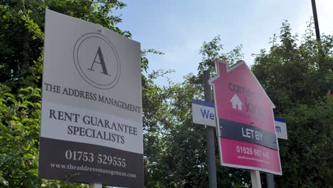 Two-estate-agents-signs-in-Slough-offering-letting-services-United-Kingdom-June-2024