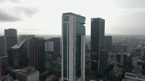 Aerial-Tall-glass-real-estate-building,-Paseo-de-la-Reforma-Mexico-City