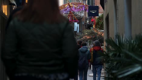 People-on-busy-Old-Town-street-in-Nice,-France,-static-low-angle-view