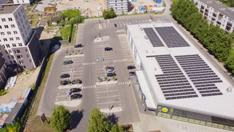 Lidl-supermarket-with-solar-panels-on-top,-aerial-orbit-view