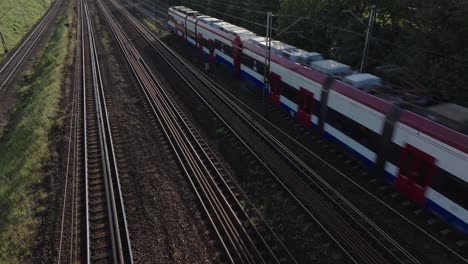 Drone-shot-of-train,-panning-into-a-city-view