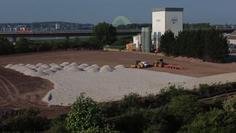 Vista-Aérea-Rodeando-Vehículos-De-Construcción-Trabajando-En-Una-Mañana-Soleada-Poniendo-La-Primera-Piedra-En-Una-Nueva-Urbanización.