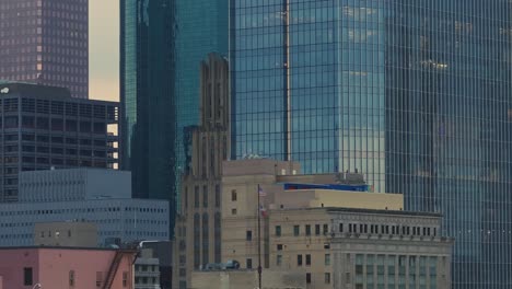 Close-up-shot-of-Houston's-skyscrapers-with-US-and-Texas-flag