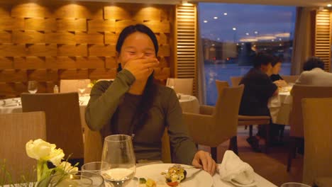 Portrait-Of-A-Happy-Female-Tourist-Having-Dinner-During-Danube-River-Cruise-In-Linz,-Austria