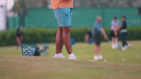 A-golfer-practicing-at-the-golf-club-in-the-evening-in-Dubai,-United-Arab-Emirates